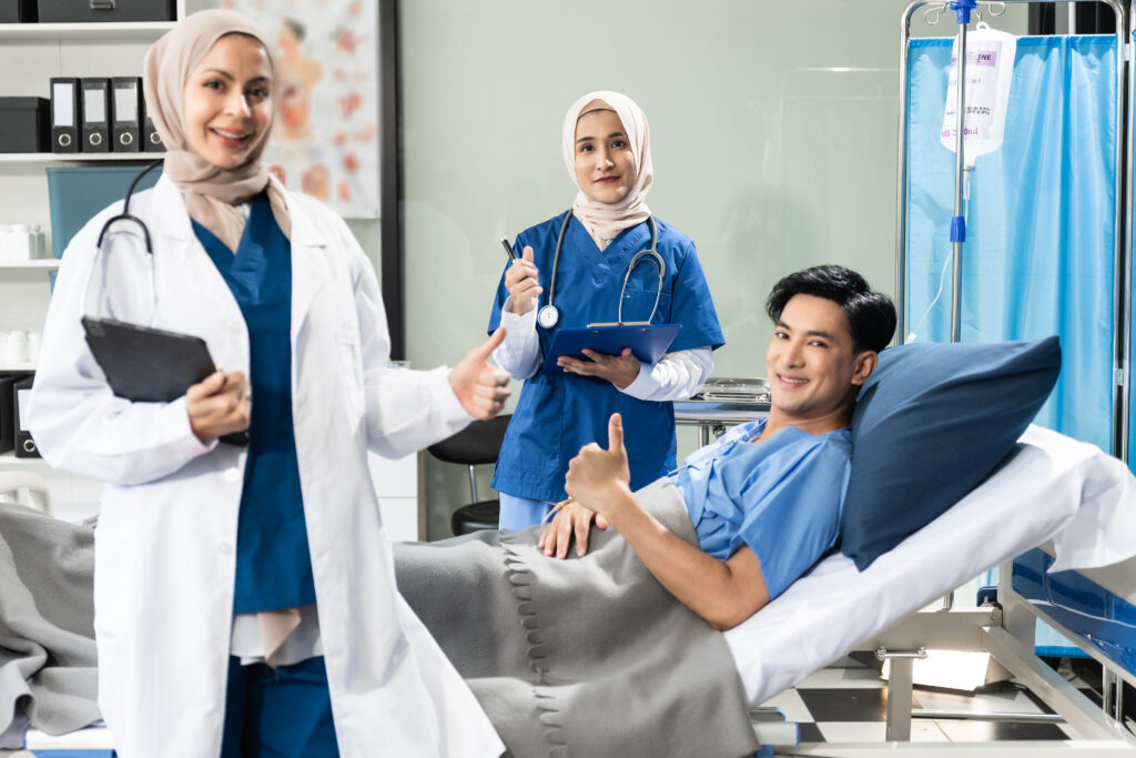 Female doctor and assistant provide expert care during a follow-up health examination for a male patient, emphasizing teamwork and trust in modern medical practice.